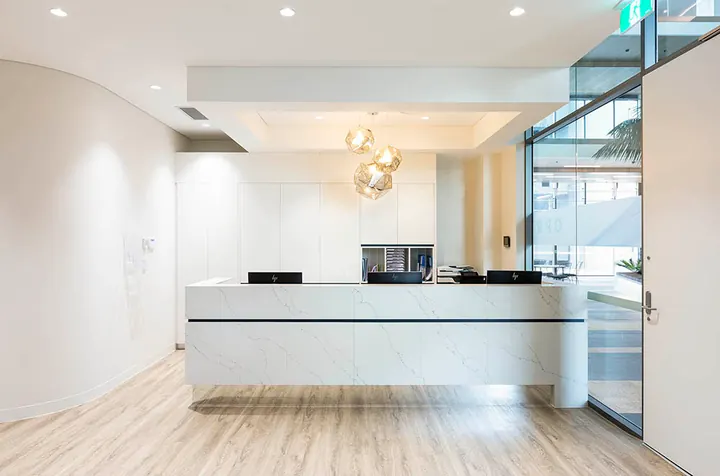 clean white and modern styled dentist reception desk fit out
